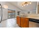 Kitchen with a double sink, stainless steel dishwasher, and balcony access at 1575 W Warm Springs Rd # 121, Henderson, NV 89014