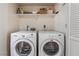 Laundry room with a washer and dryer and cleaning supplies on the shelf at 1575 W Warm Springs Rd # 121, Henderson, NV 89014