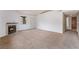 Living room boasts a cozy fireplace, carpet flooring, and an entryway door at 1575 W Warm Springs Rd # 121, Henderson, NV 89014