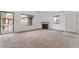 Living room with a fireplace and balcony access in a neutral colored condo at 1575 W Warm Springs Rd # 121, Henderson, NV 89014