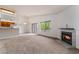 Spacious living room featuring a cozy fireplace, large window, and sliding door at 1575 W Warm Springs Rd # 121, Henderson, NV 89014
