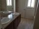 Bathroom with double sinks, neutral color scheme, and coordinated fixtures at 212 Orland St # 17, Las Vegas, NV 89107