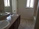 Bathroom with double sinks, neutral color scheme, and coordinated fixtures at 212 Orland St # 17, Las Vegas, NV 89107