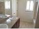 Bright bathroom featuring double sinks, neutral countertops, and tile flooring at 212 Orland St # 17, Las Vegas, NV 89107