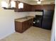 An efficient kitchen showcasing wood cabinets, tile floors, and modern appliances at 212 Orland St # 17, Las Vegas, NV 89107