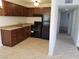A kitchen featuring wood cabinetry, tile floors, and a full suite of black appliances at 212 Orland St # 17, Las Vegas, NV 89107