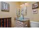 Chic bathroom featuring a vessel sink, decorative mirrors, and a butterfly-themed decor at 2137 Point Mallard Dr, Henderson, NV 89012