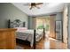 Comfortable bedroom with a wrought iron bed frame, wood floors, and a large window at 2137 Point Mallard Dr, Henderson, NV 89012