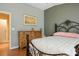 Cozy bedroom featuring an ornate wrought iron bed frame, dresser, and neutral decor at 2137 Point Mallard Dr, Henderson, NV 89012