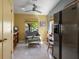 Charming breakfast nook with a window view, wicker furniture, and a stainless steel refrigerator at 2137 Point Mallard Dr, Henderson, NV 89012