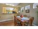 Inviting dining room with wood floors, a decorative table setting, and kitchen access at 2137 Point Mallard Dr, Henderson, NV 89012