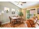 Bright dining room with wood floors, a modern ceiling fan, and a sliding door to the backyard at 2137 Point Mallard Dr, Henderson, NV 89012