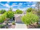 Inviting single-story home with a neutral color scheme and mature trees, enhancing the curb appeal at 2137 Point Mallard Dr, Henderson, NV 89012