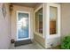 Close-up of an inviting front entrance with a stylish blue door, sidelight window, and modern outdoor lighting at 2137 Point Mallard Dr, Henderson, NV 89012