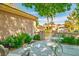 Cozy front patio with stylish seating and a charming gate, enhanced by lush plants for a relaxing outdoor retreat at 2137 Point Mallard Dr, Henderson, NV 89012