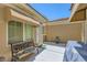 Charming backyard patio with seating bench, grill, and convenient awning for shade at 2213 Carrier Dove Way, North Las Vegas, NV 89084