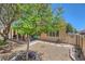 Well-maintained backyard featuring a covered patio and mature trees at 2213 Carrier Dove Way, North Las Vegas, NV 89084