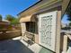 Inviting backyard patio space with a quaint bench, lovely garden and entry door at 2213 Carrier Dove Way, North Las Vegas, NV 89084