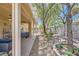 Beautiful backyard features a rock garden, covered patio, and green landscaping at 2213 Carrier Dove Way, North Las Vegas, NV 89084