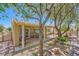 Beautiful backyard boasts covered patio, mature trees, and charming landscape at 2213 Carrier Dove Way, North Las Vegas, NV 89084