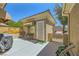 Cozy backyard patio with seating area, barbecue, and convenient access gate at 2213 Carrier Dove Way, North Las Vegas, NV 89084