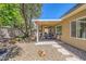 Outdoor patio surrounded by a rock garden and well-manicured trees at 2213 Carrier Dove Way, North Las Vegas, NV 89084