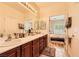 Bathroom with dual sinks and a view into the bedroom at 2213 Carrier Dove Way, North Las Vegas, NV 89084