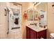 Well-lit bathroom features a single vanity with sink and large mirror at 2213 Carrier Dove Way, North Las Vegas, NV 89084