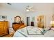 Comfortable bedroom with a ceiling fan, wooden furniture and ensuite bathroom at 2213 Carrier Dove Way, North Las Vegas, NV 89084