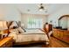 The main bedroom is furnished with a queen bed and a ceiling fan at 2213 Carrier Dove Way, North Las Vegas, NV 89084