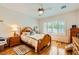 This bedroom features a window with shutter, ceiling fan, and matching dressers at 2213 Carrier Dove Way, North Las Vegas, NV 89084