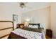 Bedroom with decorative chair, a fan and nice window light at 2213 Carrier Dove Way, North Las Vegas, NV 89084