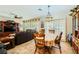 Comfortable dining area connected to the living room, featuring a floral table setting and shuttered windows at 2213 Carrier Dove Way, North Las Vegas, NV 89084