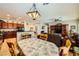 Open dining and kitchen area with an pendant light, breakfast bar, and seamless flow to living spaces at 2213 Carrier Dove Way, North Las Vegas, NV 89084