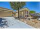 Inviting single-story home showcasing drought-resistant landscaping, neutral tones, and a convenient two-car garage at 2213 Carrier Dove Way, North Las Vegas, NV 89084