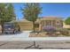 Charming single-story home featuring low maintenance landscaping, a neutral color palette, and a two-car garage at 2213 Carrier Dove Way, North Las Vegas, NV 89084