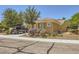 Pretty single-story home presenting desert landscaping, a neutral exterior, and a functional two-car garage at 2213 Carrier Dove Way, North Las Vegas, NV 89084