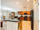 A spacious kitchen features granite counters, tile flooring, and wood cabinetry at 2213 Carrier Dove Way, North Las Vegas, NV 89084