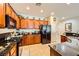 This well-appointed kitchen features tile flooring, wood cabinetry, and modern appliances at 2213 Carrier Dove Way, North Las Vegas, NV 89084