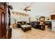 Spacious living room featuring tile floors, ceiling fan, and abundant natural light through window shutters at 2213 Carrier Dove Way, North Las Vegas, NV 89084