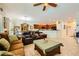 Open-concept living room and kitchen area with tile flooring, breakfast bar, and comfortable seating at 2213 Carrier Dove Way, North Las Vegas, NV 89084
