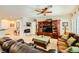 Inviting living room featuring a large entertainment center and comfortable leather sofa seating at 2213 Carrier Dove Way, North Las Vegas, NV 89084