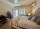 Warm and inviting main bedroom featuring a large bed, door to outside, and a comfortable chair at 2213 Carrier Dove Way, North Las Vegas, NV 89084