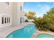 Beautiful backyard with large pool, jacuzzi, and lush landscaping at 2236 Timber Rose Dr, Las Vegas, NV 89134