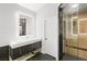 Bathroom featuring single vanity, quartz countertop, bronze hardware, and a custom glass shower at 2236 Timber Rose Dr, Las Vegas, NV 89134