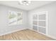 Bedroom features modern light fixture, plank floors, a window, and closet with sliding doors at 2236 Timber Rose Dr, Las Vegas, NV 89134