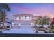 Charming two-story home featuring a three-car garage and manicured front yard with mature landscaping at 2236 Timber Rose Dr, Las Vegas, NV 89134