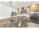 Beautiful kitchen features stainless steel appliances, wooden cabinets, marble island, and large sink at 2236 Timber Rose Dr, Las Vegas, NV 89134