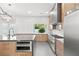 Modern kitchen with stainless steel appliances, large island, and sleek countertops and modern backsplash at 2236 Timber Rose Dr, Las Vegas, NV 89134