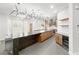 Bright kitchen boasts wood cabinets, stainless appliances, a marble island, and modern lighting at 2236 Timber Rose Dr, Las Vegas, NV 89134